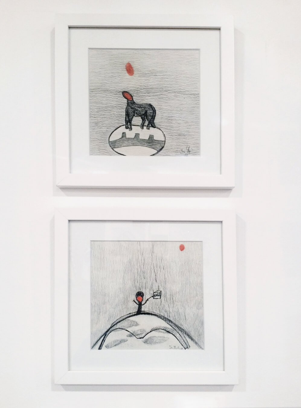 Two framed drawings.